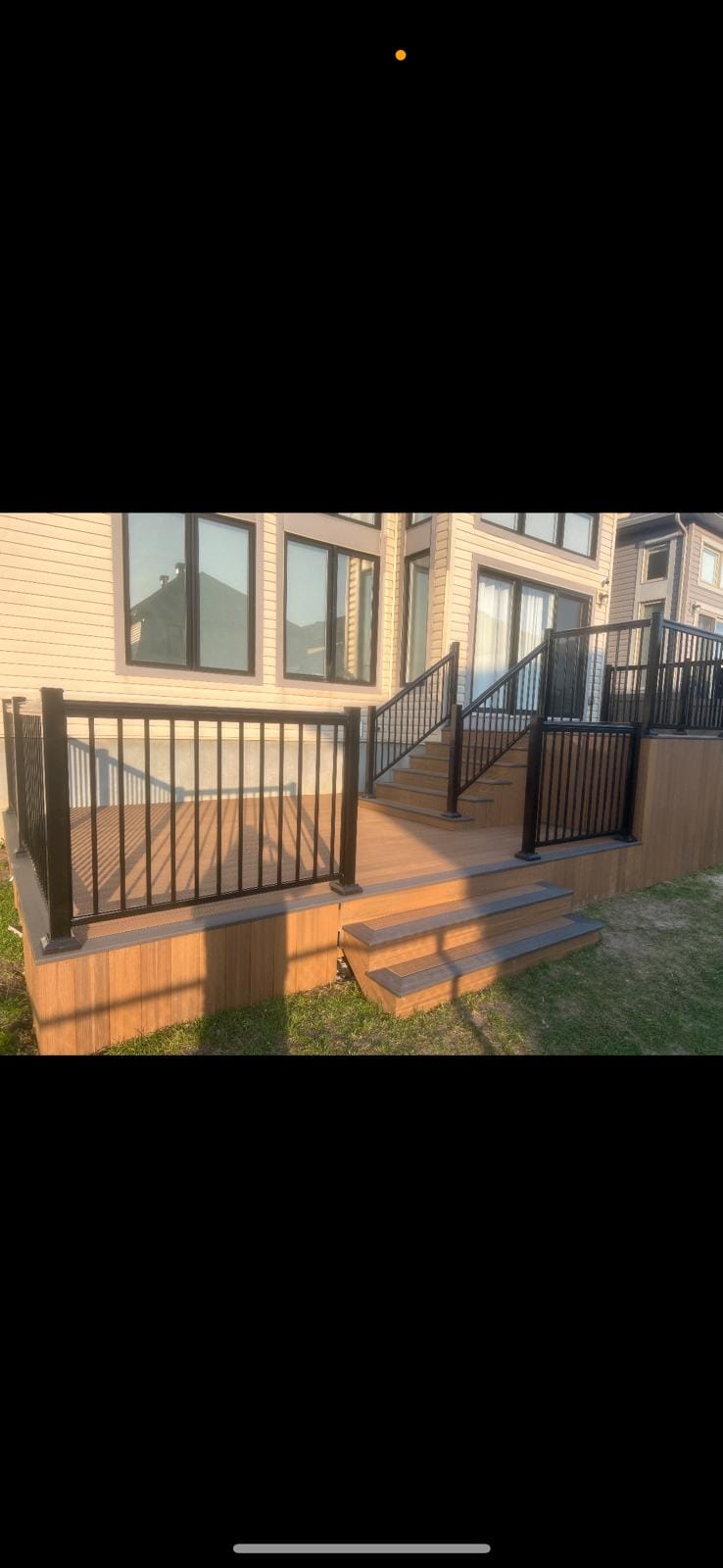 Multi-level composite deck with black aluminum railings