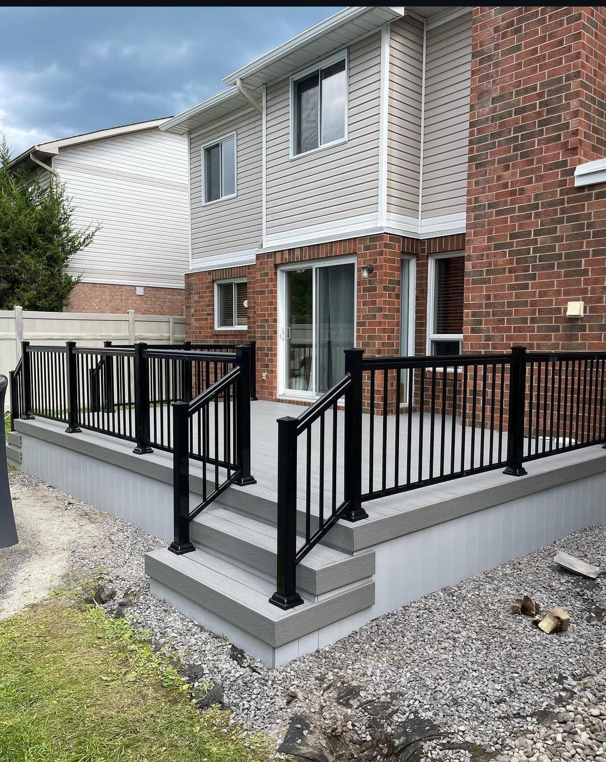 Grey composite deck with black railings and staircase