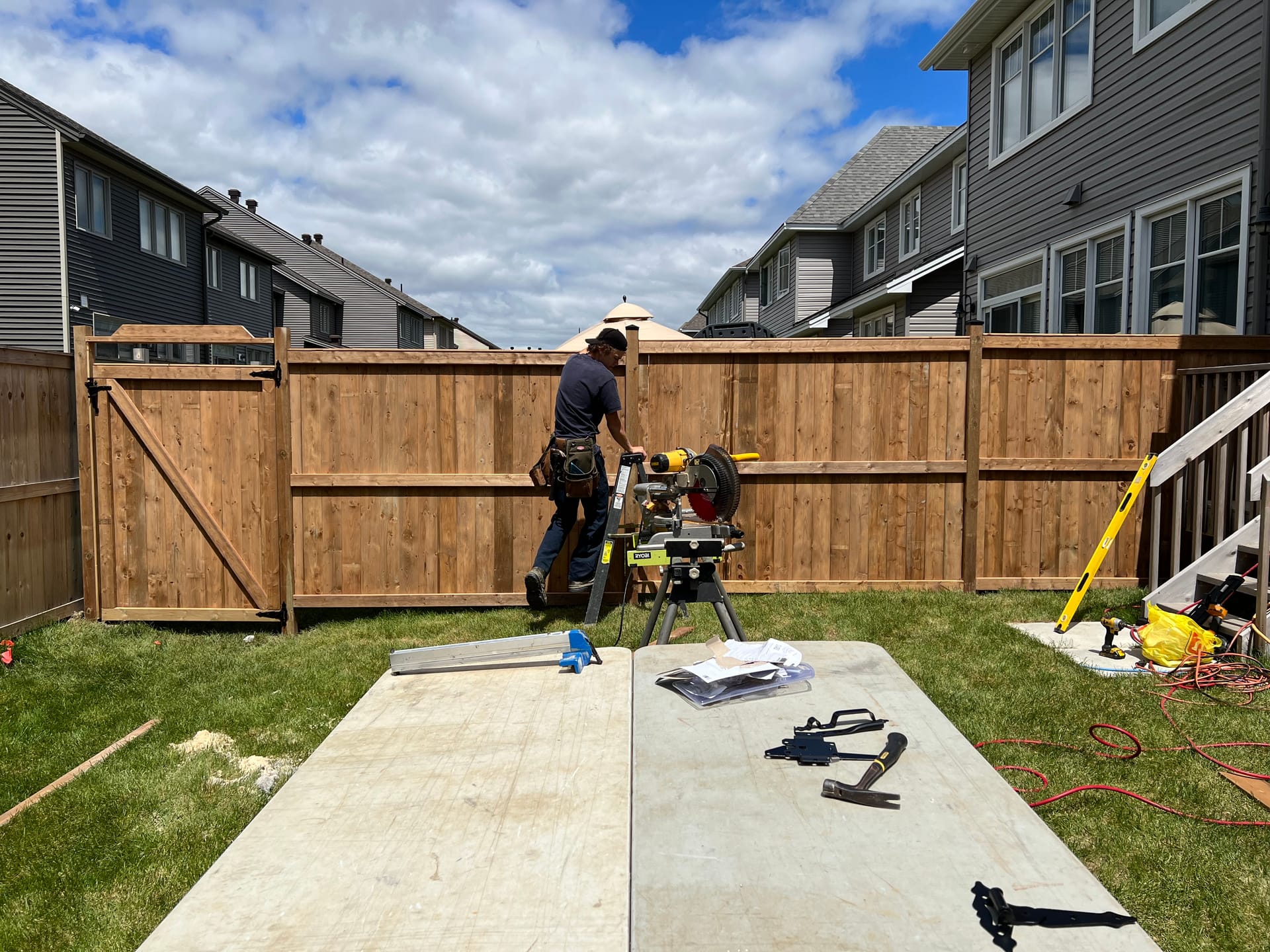 Cedar wood privacy fence installation with gate