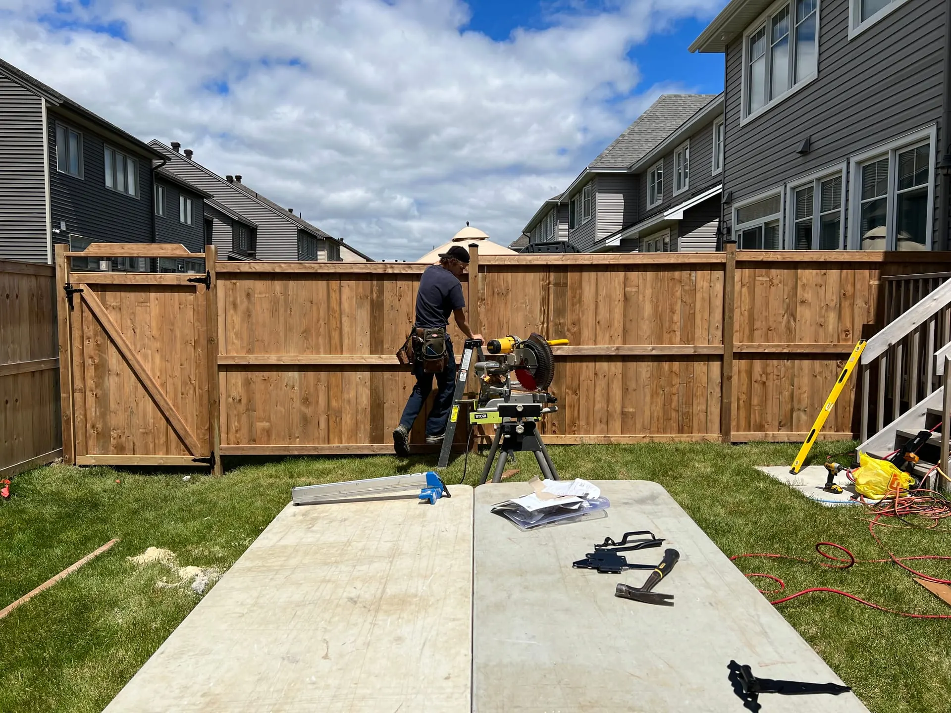Cedar wood privacy fence installation with gate