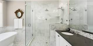 Modern bathroom renovation with wood-panel shower and round backlit mirrors