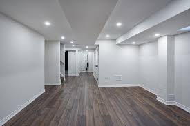 Finished basement with hardwood floors and recessed lighting