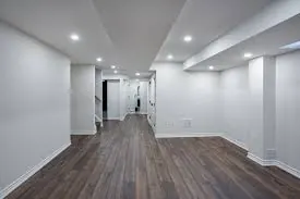 Finished basement with hardwood floors and recessed lighting
